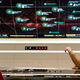 Ethan Peck's Spock (left) stands at attention in front of a large star chart, while Anson Mount's Captain Pike (right) sits in a seat, looking away from the map with his arm raised.